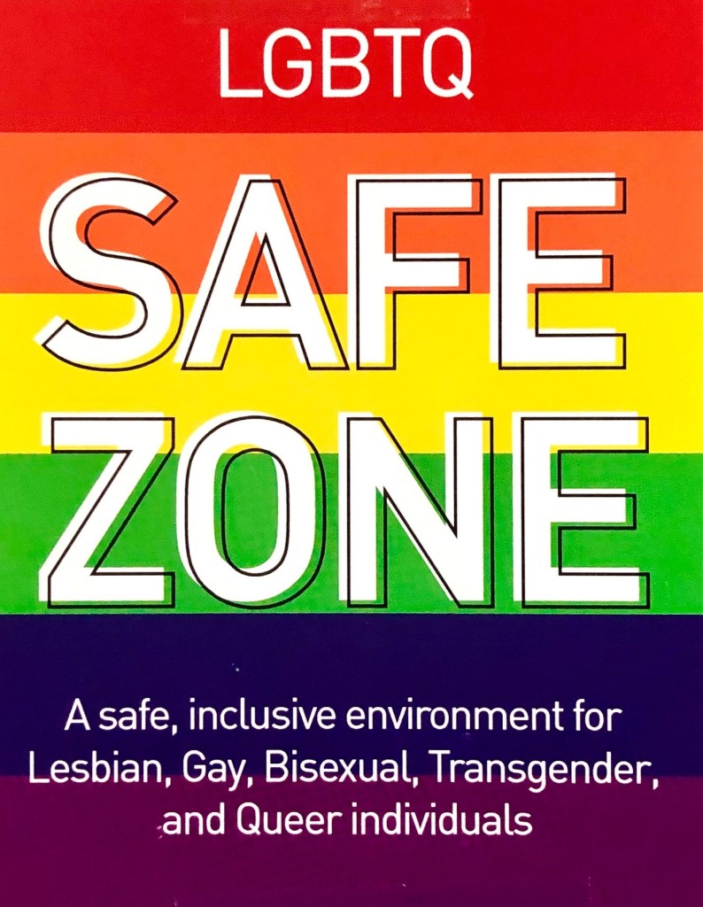 A Pride flag with the words LGBTQ Safe Zone, a safe, inclusive environment for Lesbian, Gay, Bisexual, Transgender, and Queer individuals on it.
